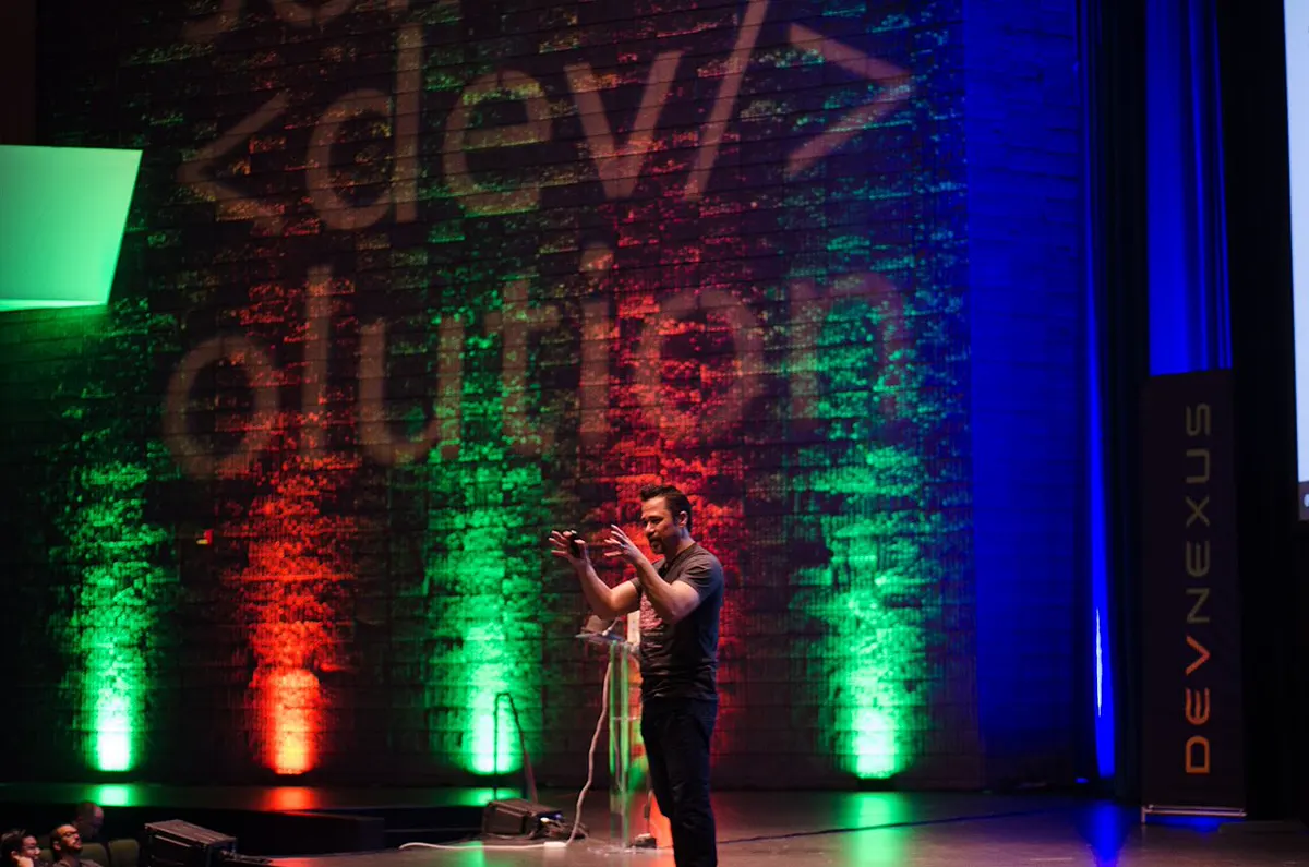 Illustrative photograph: a speaker presenting at the unrelated Devnexus 2017 conference